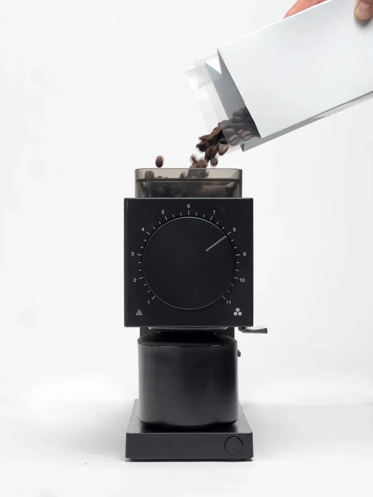 Coffee grinder with beans being poured in